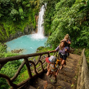 a family hiking at Rio Celeste waterfall in Costa Rica