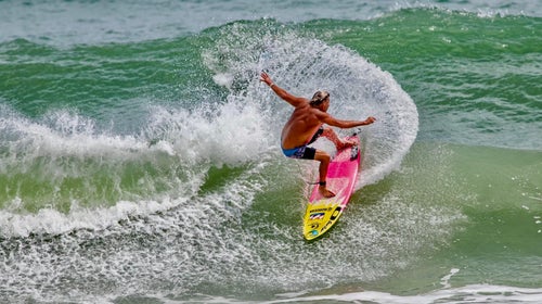 Charley Hajek catches.a wave
