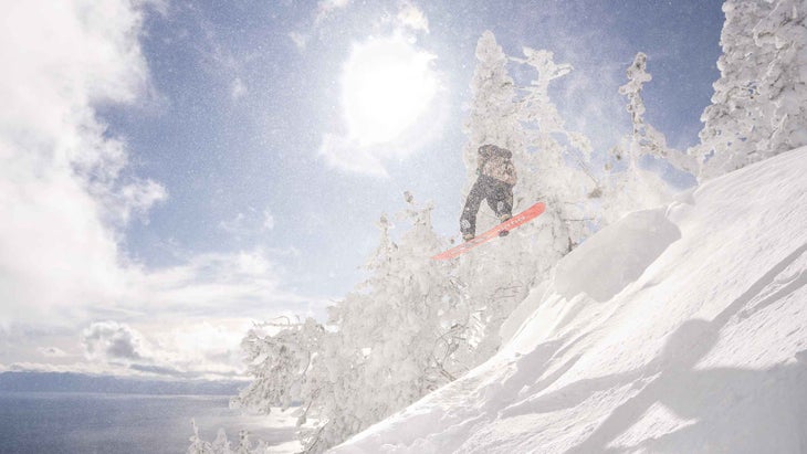 A snowboarder catching air