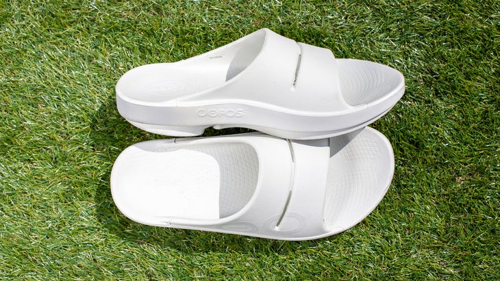 OOFOS recovery sandals on grass