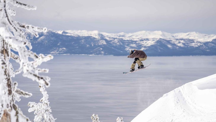 A man catching air while snowboarding