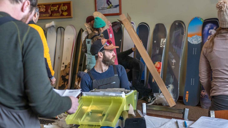 A man looking at snowboards