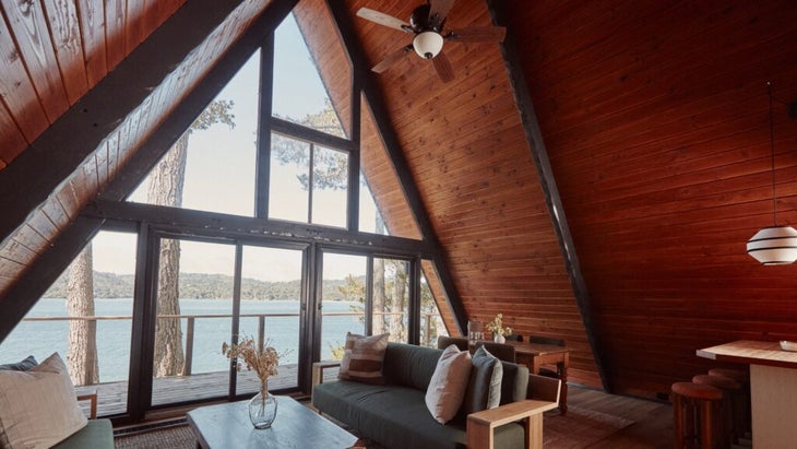 A shot of the Lodge at Marconi's A-frame cabin, looking from its spacious living room out to the porch and Tomales Bay in front of it. 