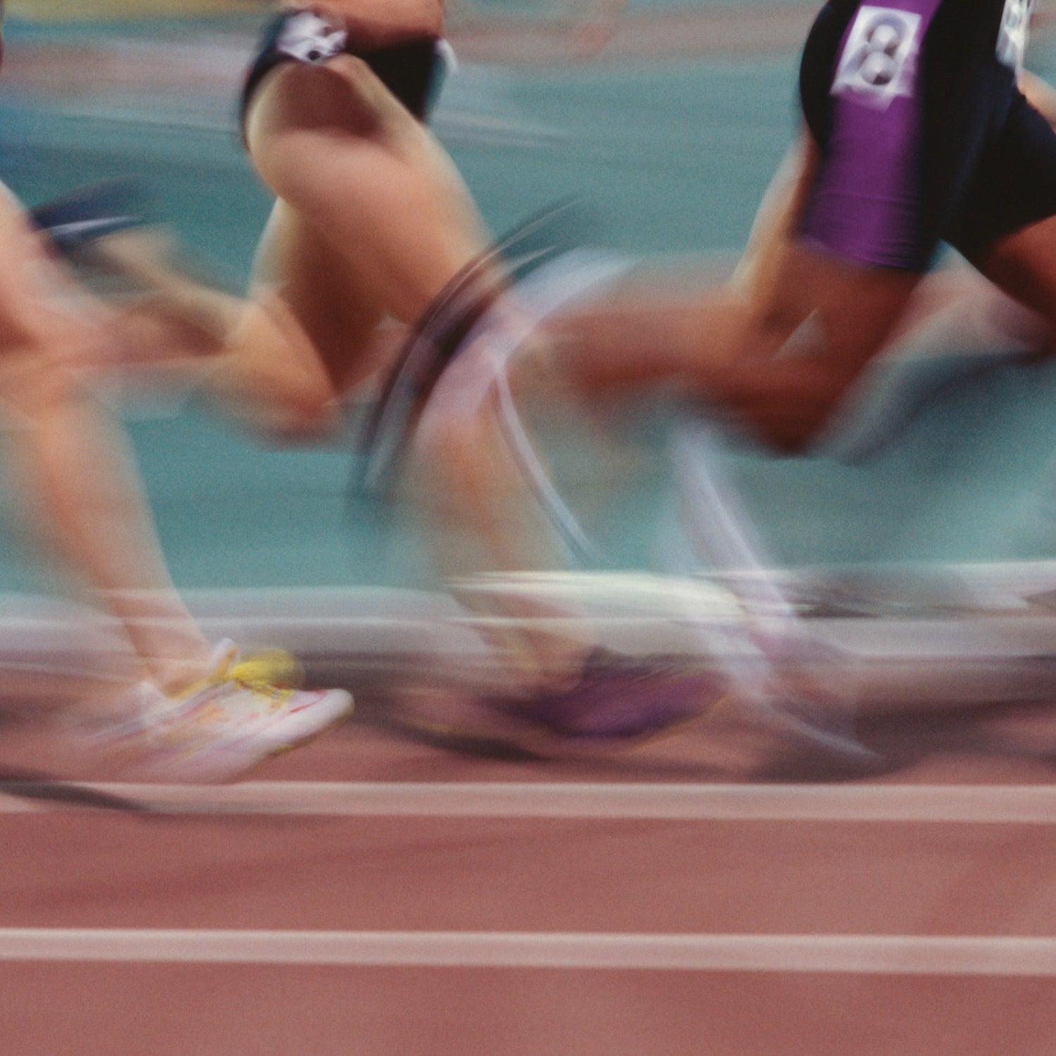 blurred image of women track runners in long distance race