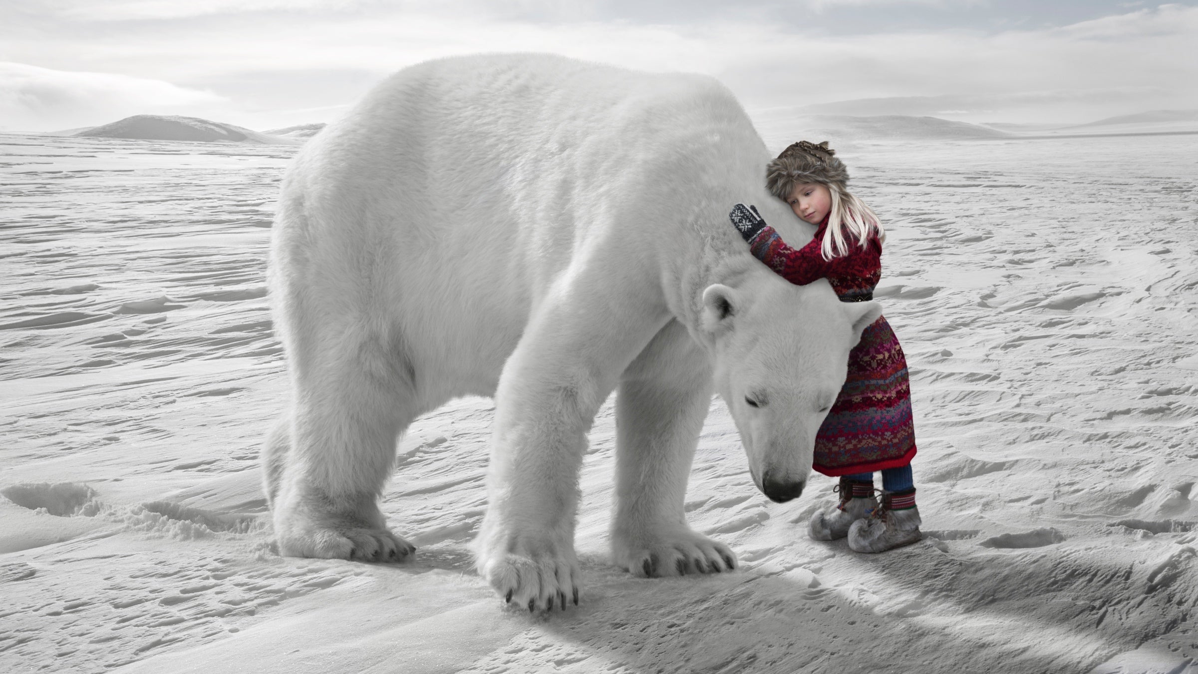 A girl in traditional Laplander clothing hugs a massive polar bear on the Arctic ice.