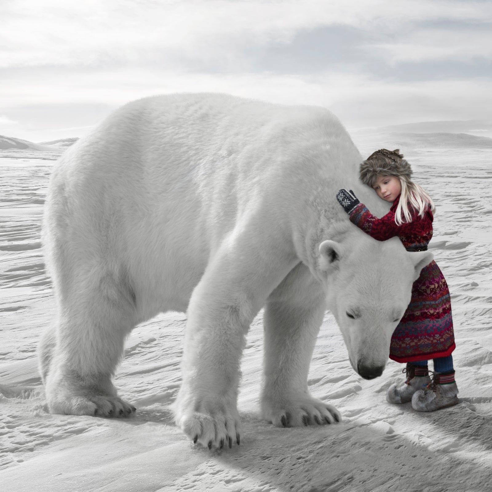 A girl in traditional Laplander clothing hugs a massive polar bear on the Arctic ice.