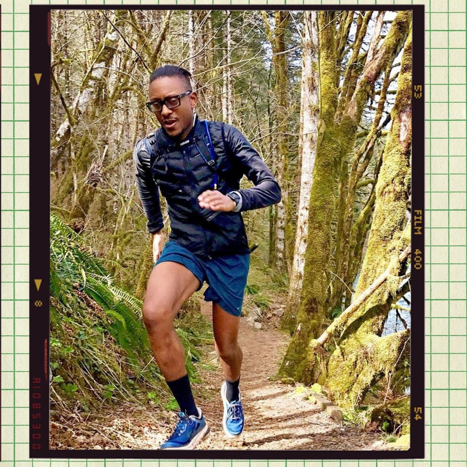 An image of a chef Gregory Gourdet in the forest running up a hill.