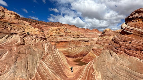 hiker on Coyote Buttes North The Wave trail, Arizona