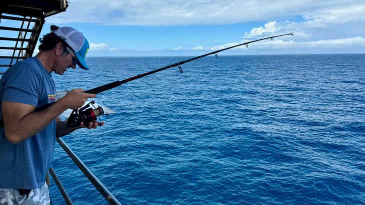 man fishing from lighthouse