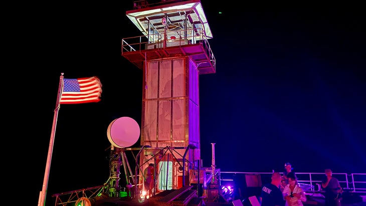 lighthouse tower in ocean at night