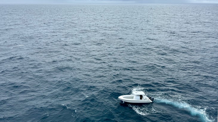 boat below lighthouse