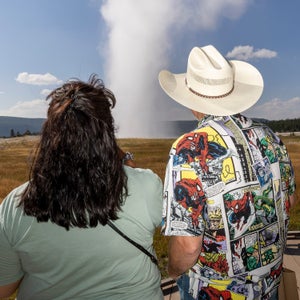 Visitors watch an eruption of Old Faithful in Yellowstone Park Sunday August 11, 2024.