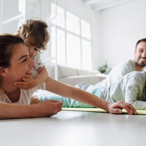 kids doing yoga on mat with parents