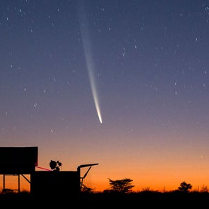 Comet Tsuchinshan-ATLAS, or Comet C/2023 A3, above a cropping of buildings in the desert