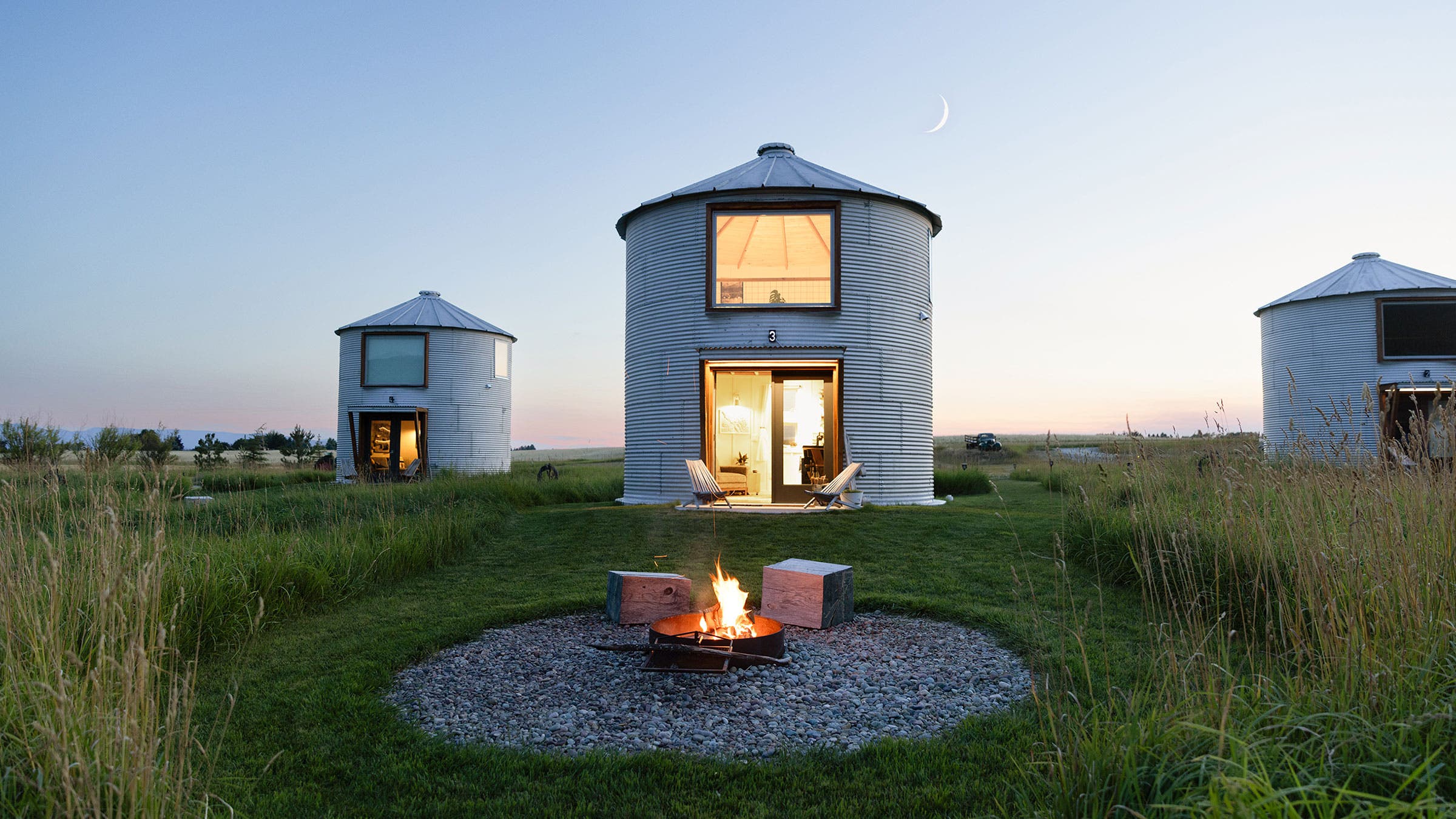 Clark Farm Silos airbnb with a bonfire at night near Kalispell, Montana