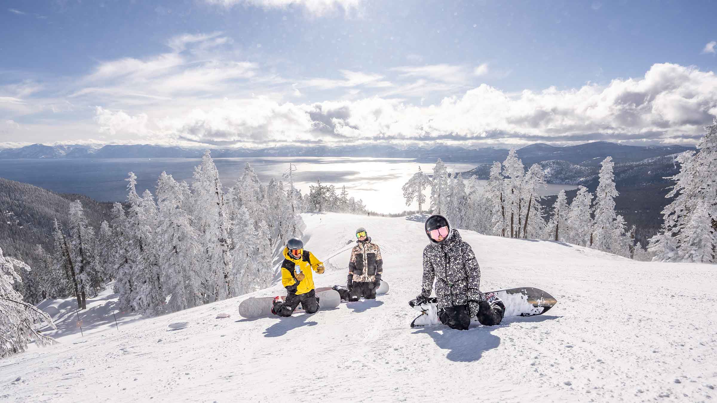 Three people snowboarding