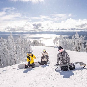 Three people snowboarding