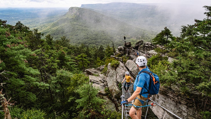 climbers on rope bridge on Eagle Cliff Via Ferrata in New York