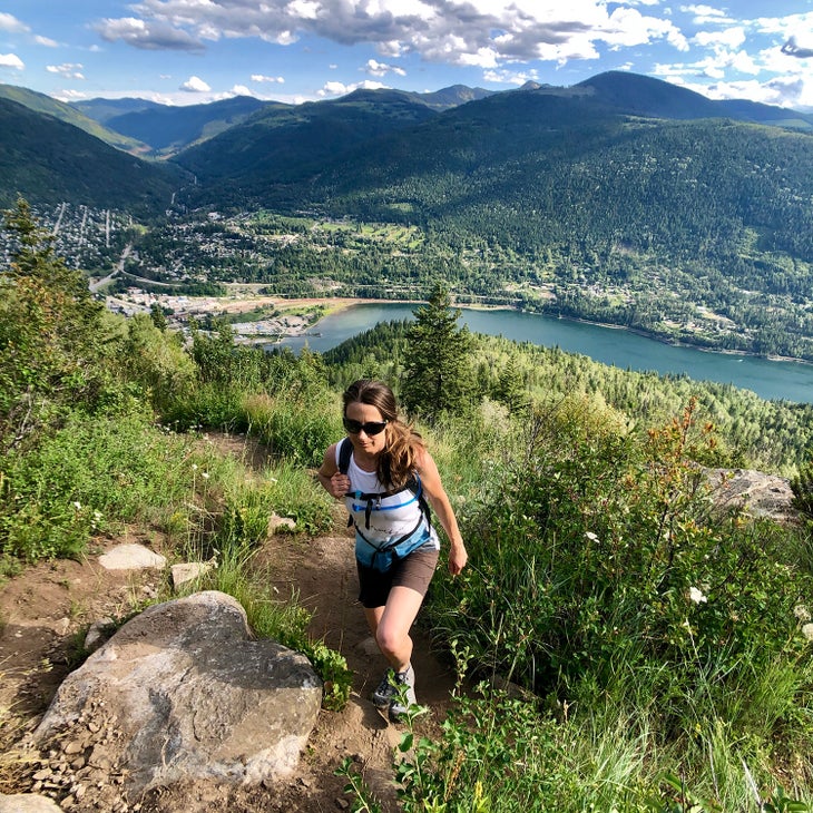 jayme moye hiking on a trail above her home in nelson british columbia