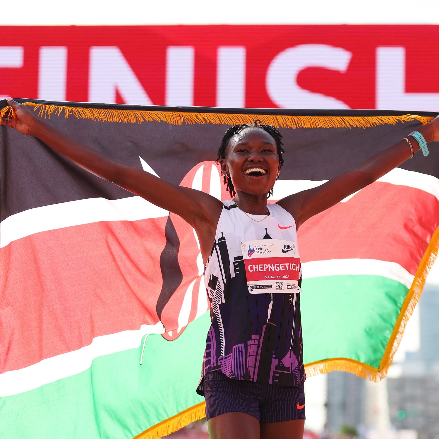 Ruth Chepngetich poses at the finish line of the 2024 Chicago Marathon after breaking the world record