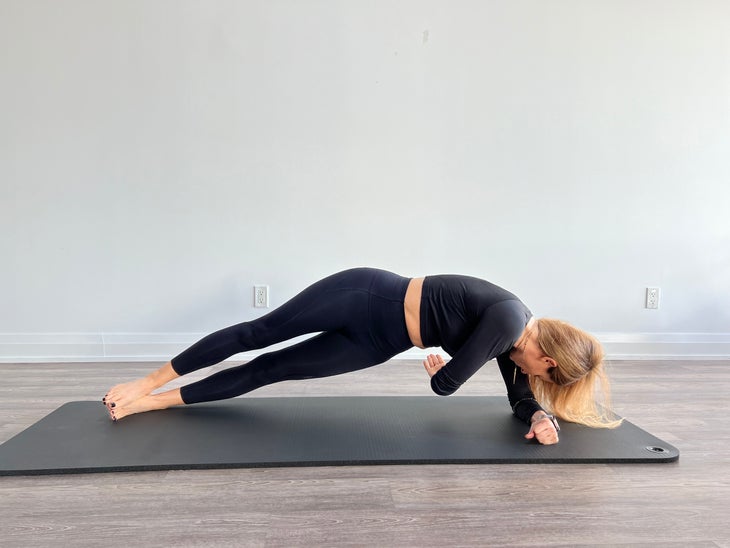 Woman in side plank with rotation