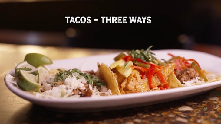 three tacos on a white plate