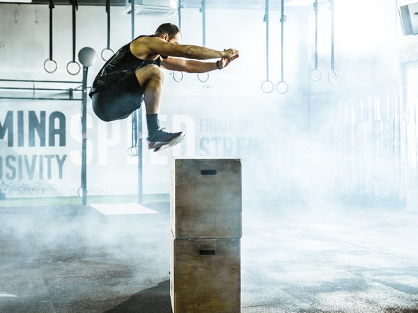 An athlete in midair performing a box jump to increase muscle power