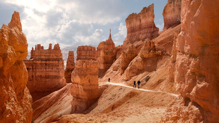 man hiking along navajo trail in bryce canyon national park