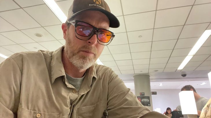 Travel writer Tim Neville takes a selfie of himself at the Newark airport wearing two sets of glasses; one is a tinted pair used as part of the FlyKitt protocol to help prevent jet lag.