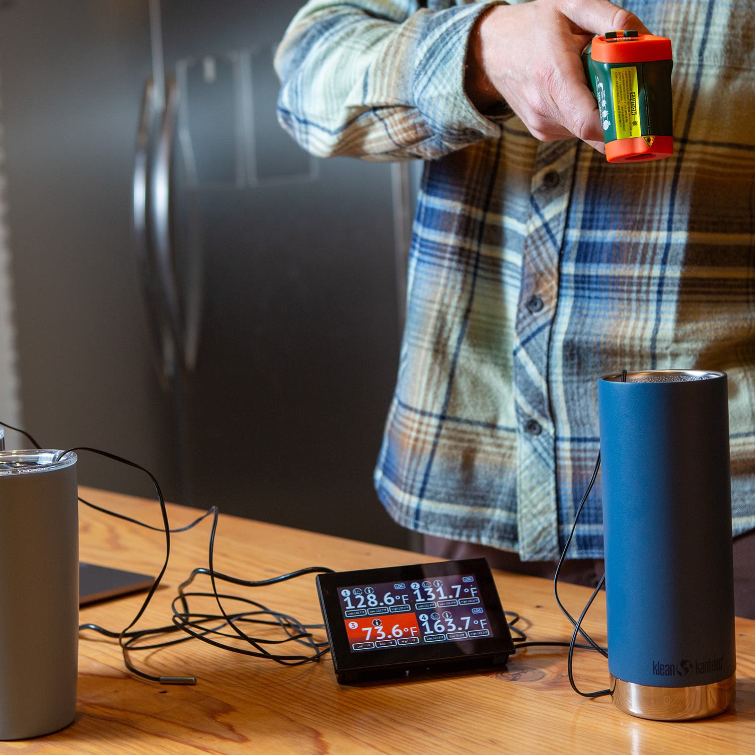 Trenkamp testing the accuracy of a laser infrared thermometer on hot water