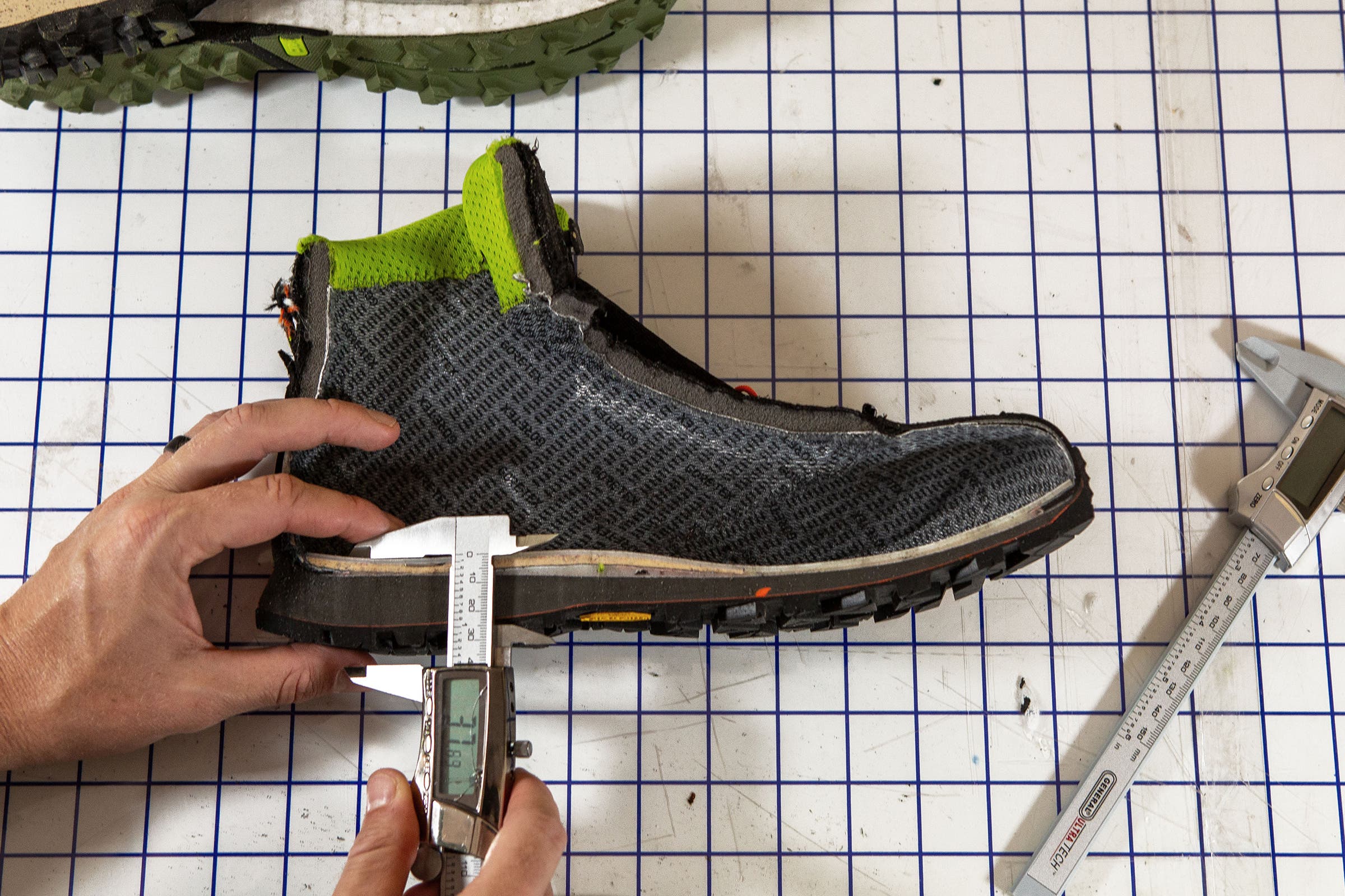 Trenkamp measures the compression of a hiking boot midsole after testing
