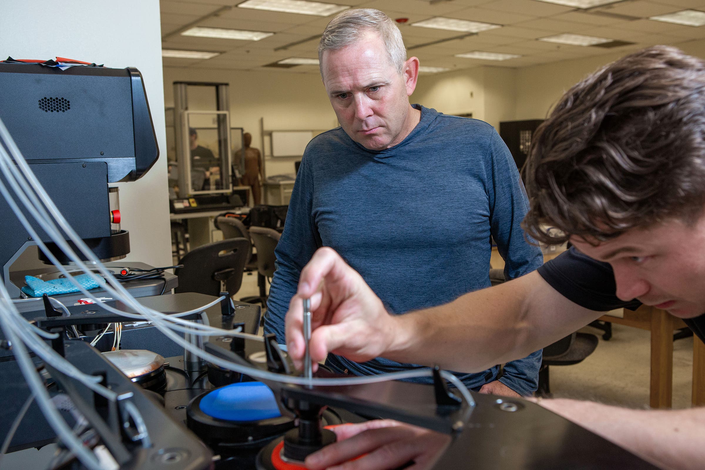 Dana Carpenter and Trevor Young conducting an experiment in the lab