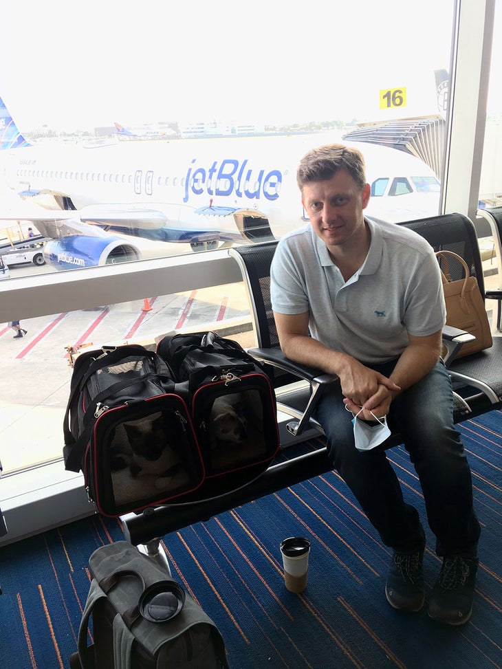 ryan krogh in an airport with his cats waiting to board a jet blue flight