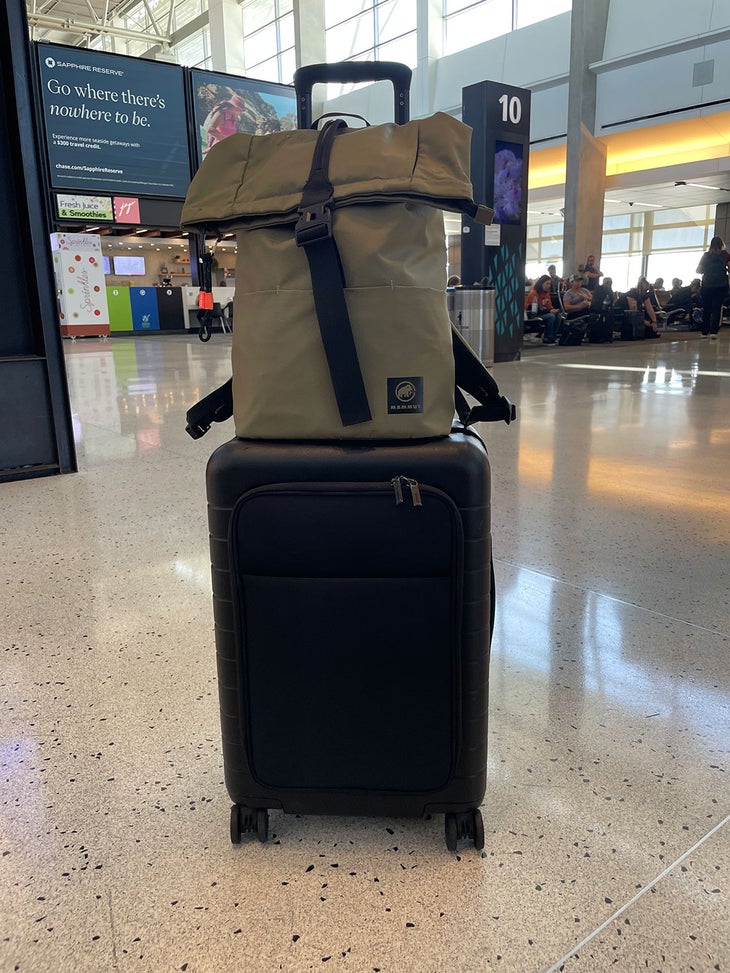 suitcase and personal item attached to each other in an airport