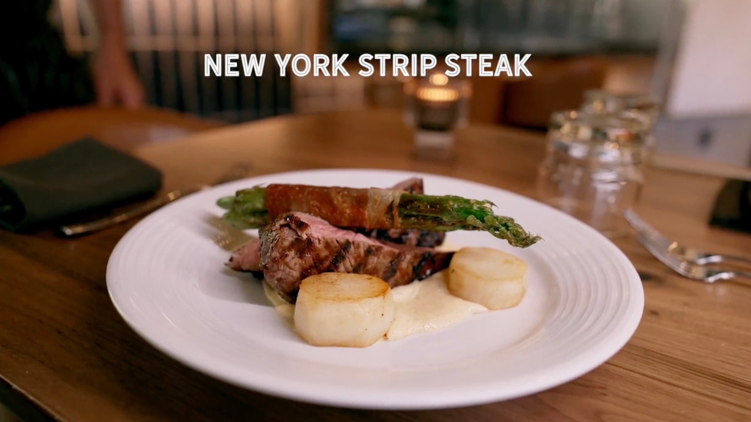 The New York strip with asparagus and scallops