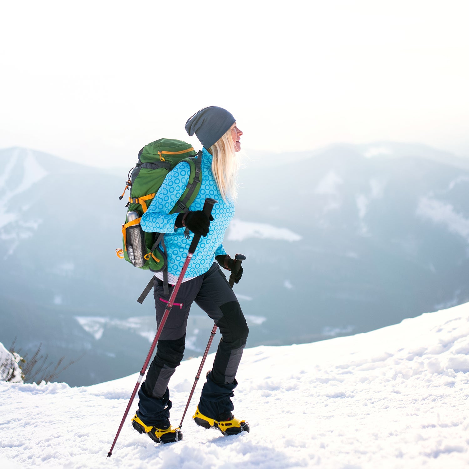 woman hiking on snowy mountain