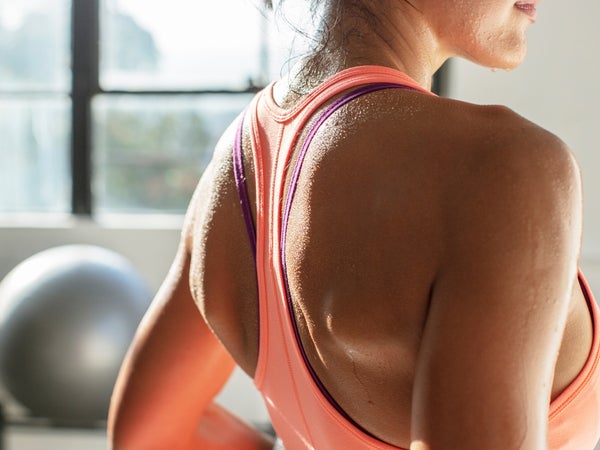 Woman in the gym wearing a sports bra and sweating