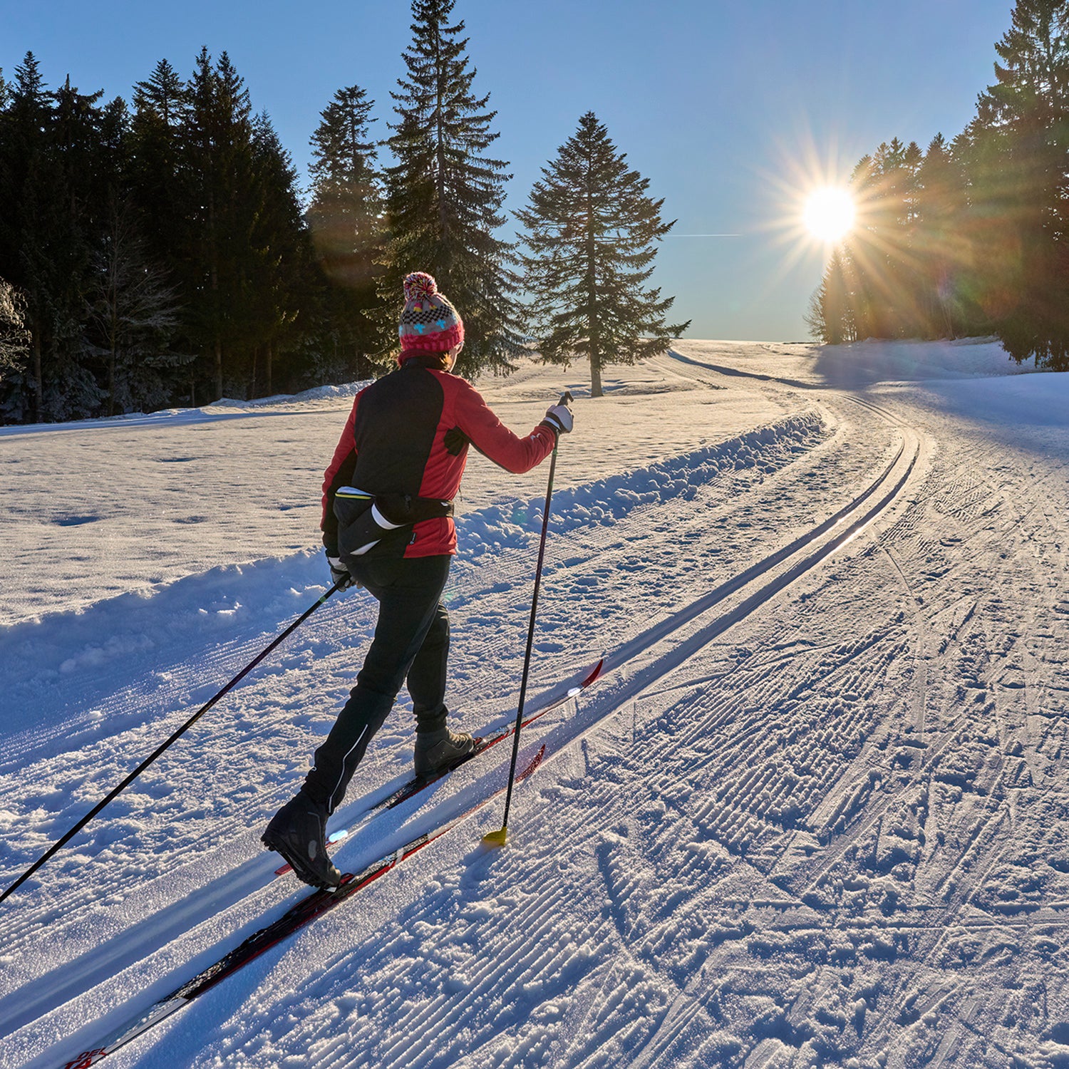 woman nordic skiing wearing layers