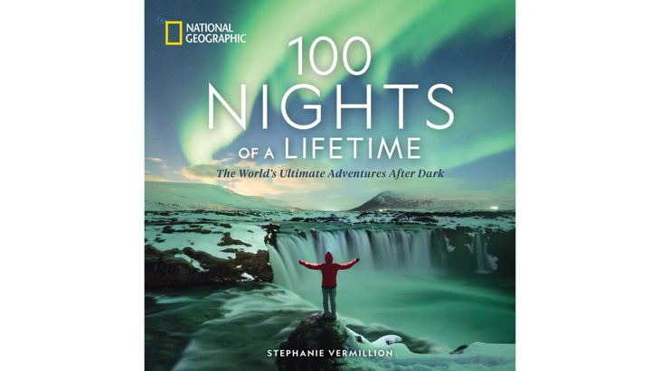 The cover of the book "100 Nights of a Lifetime," by Stephanie Vermillion, with a person overlooking a waterfall and green northern lights swirling in the sky above.