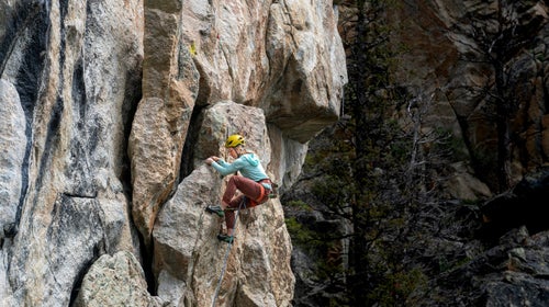 A woman climbs on lead at a crag in Montana