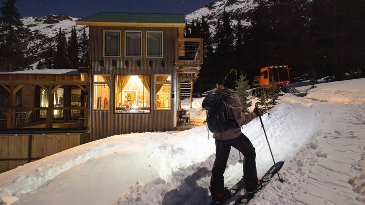 woman skinning on backcountry skis near raven's nest