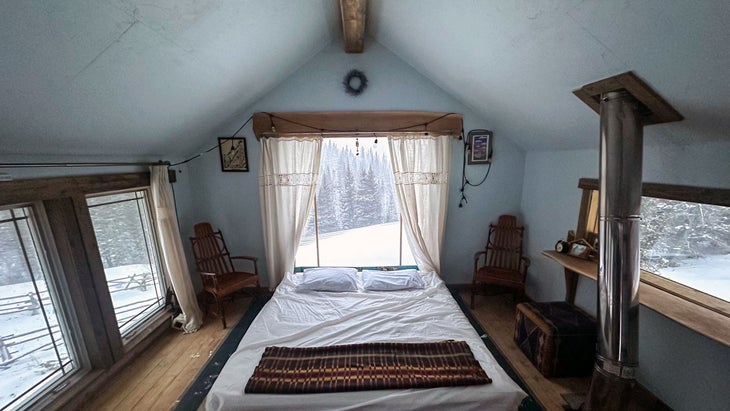 raven's nest bedroom with a three-sided view of the mountains makes this the coolest airbnb in colorado