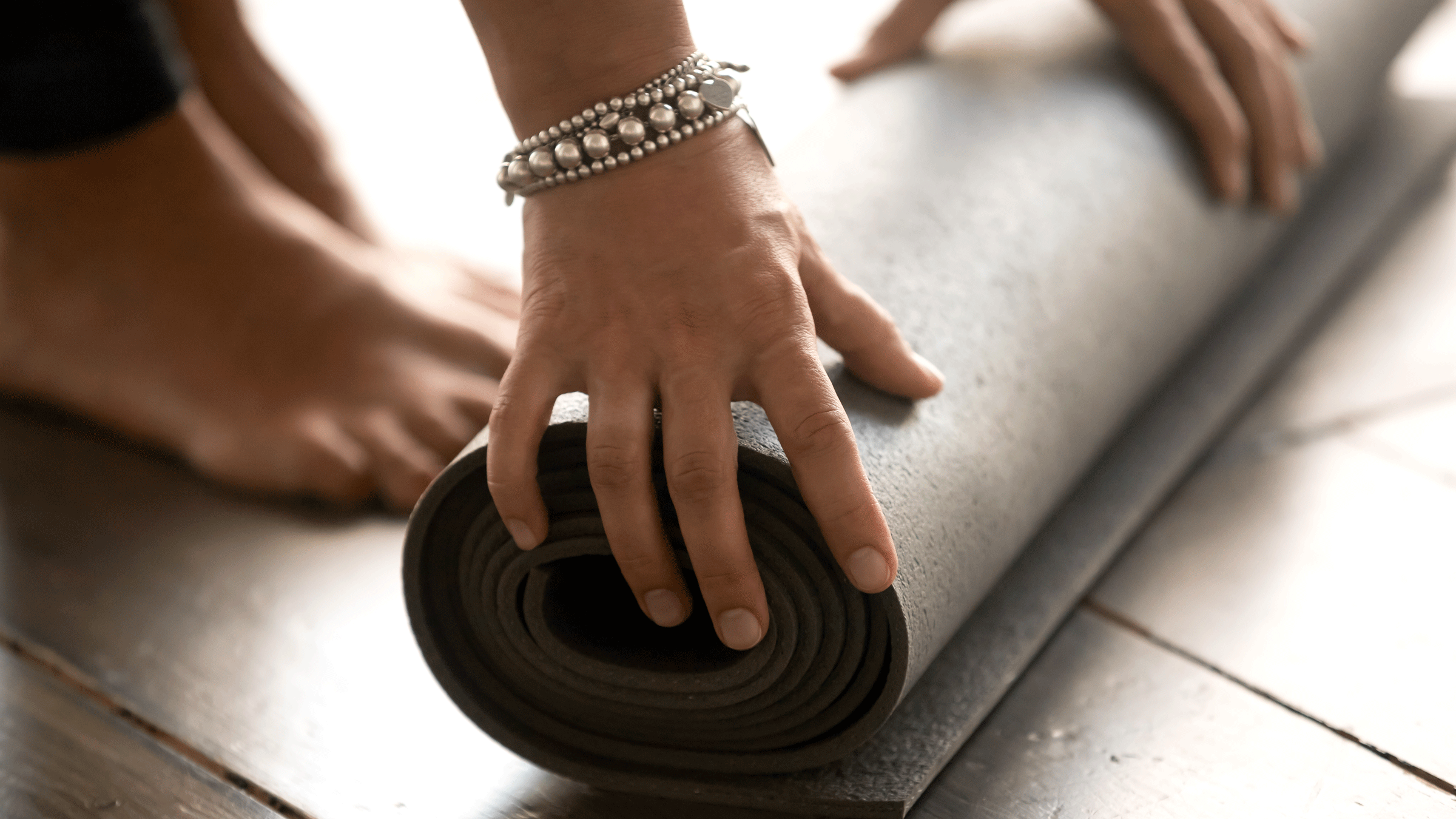 Woman unrolling her yoga mat during a yoga challenge.