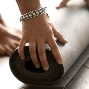 Woman unrolling her yoga mat during a yoga challenge.