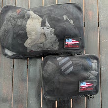 An older Asian woman running on a forest running trail behind her.