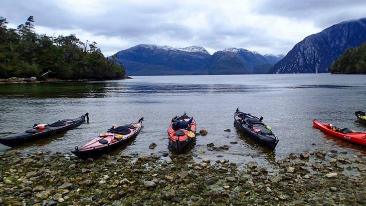 kayakers pull up on the shorline in Patagonia