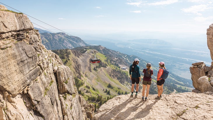 man and two women hike in Jackson, Wyoming, in summertime