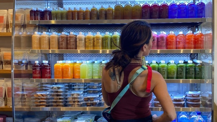 A woman looks at the Local Juicery’s refrigerated selection of 26 juice combinations and "milks" (nut- or seed-based drinks) in Sedona, Arizona.