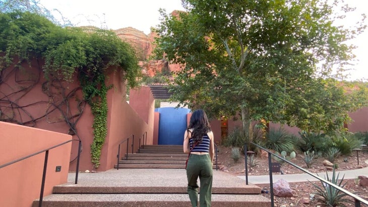 A woman walks up steps to the Mii Amo spa at the Enchantment Resort