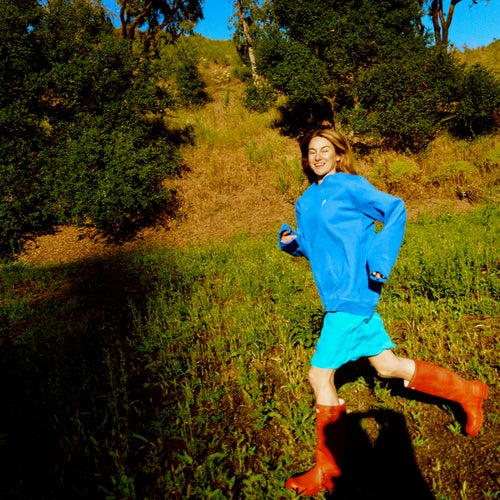 Woodley in Malibu, California, in June. Sweatshirt by Patagonia, Slip by Araks, and Rain Boots by Hunter.